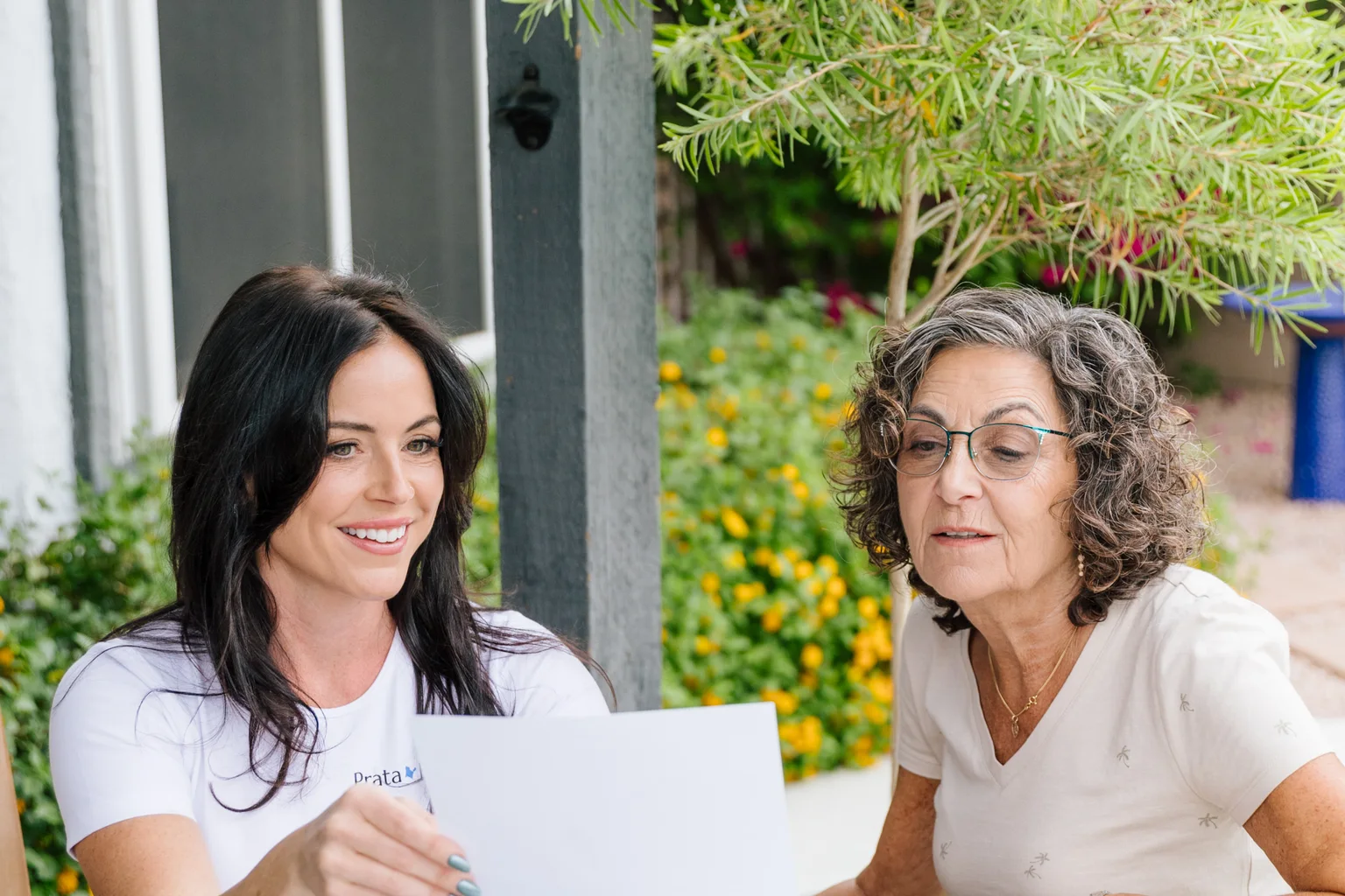 Prata Health registered nurse reviewing a written post-op care plan with a patient at home